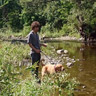 Nathan and Penny playing by the river